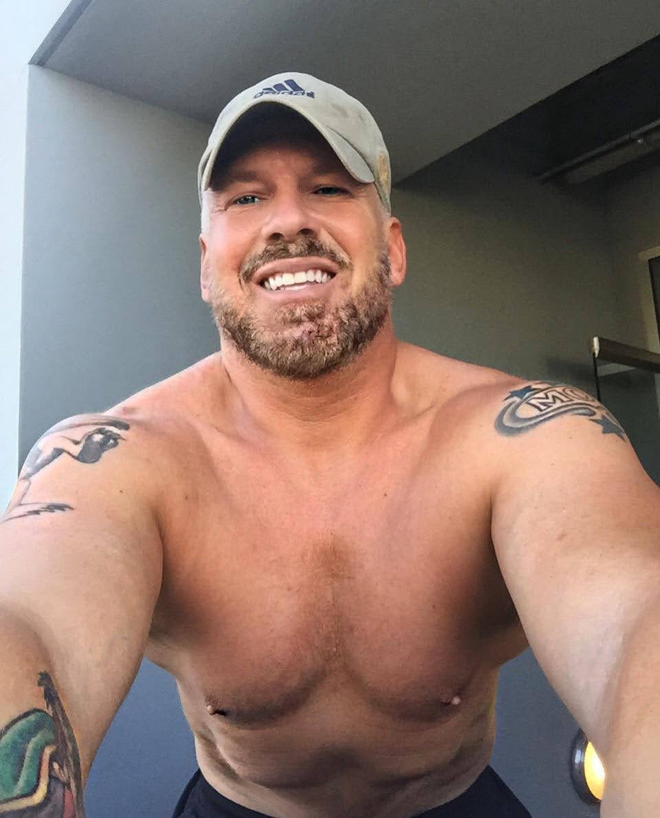 A smiling close-up portrait of the Stretch Daddy founder wearing a baseball cap